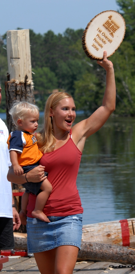 Rebecca George hoisting trophy and son